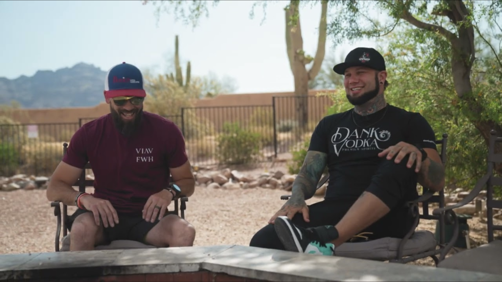 Dillin Brissette and Zack Williams sharing laughs and insights during an Uncaged Men’s Accountability Group testimonial in an outdoor setting with desert scenery.